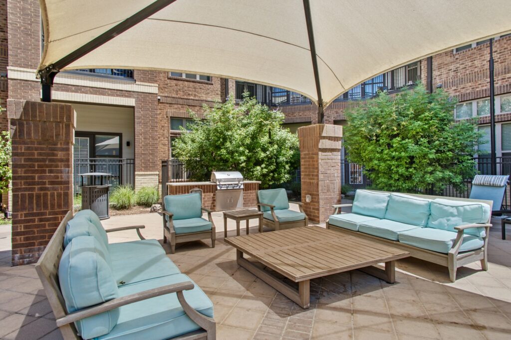 outdoor pool lounge area with seating and shade